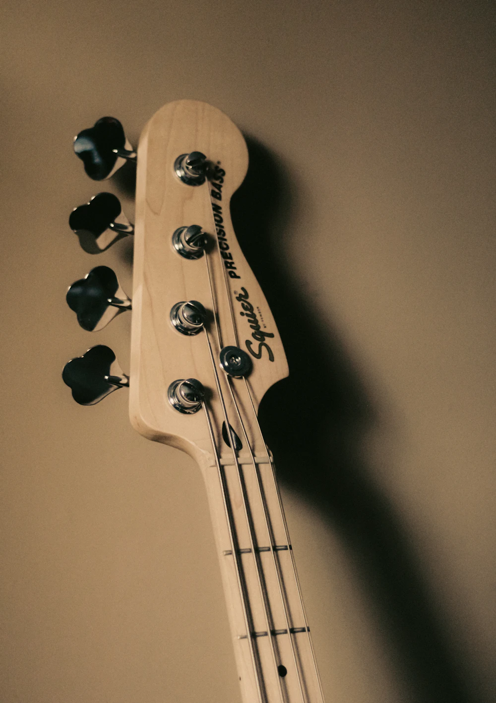 Close-up of a Fender-style bass neck and headstock