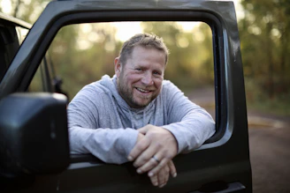 a man sitting in the back of a truck