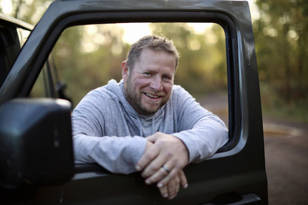 a man sitting in the back of a truck