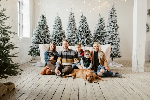 a group of people sitting on a couch with a dog