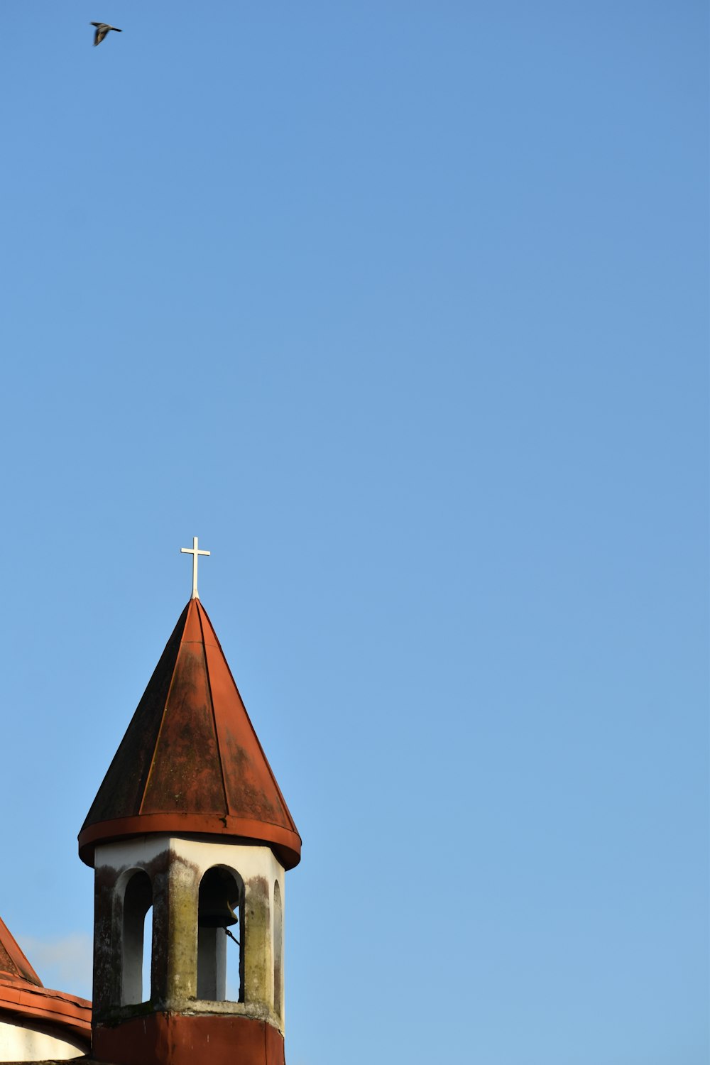 a church steeple with a cross on top