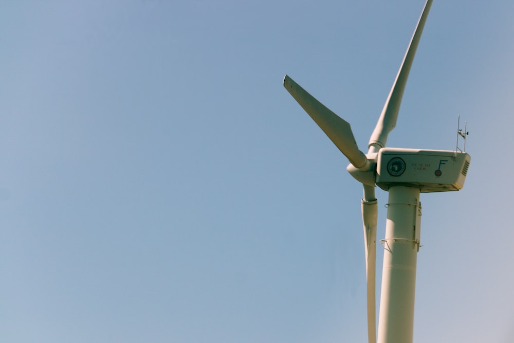 a close up of a wind turbine against a blue sky