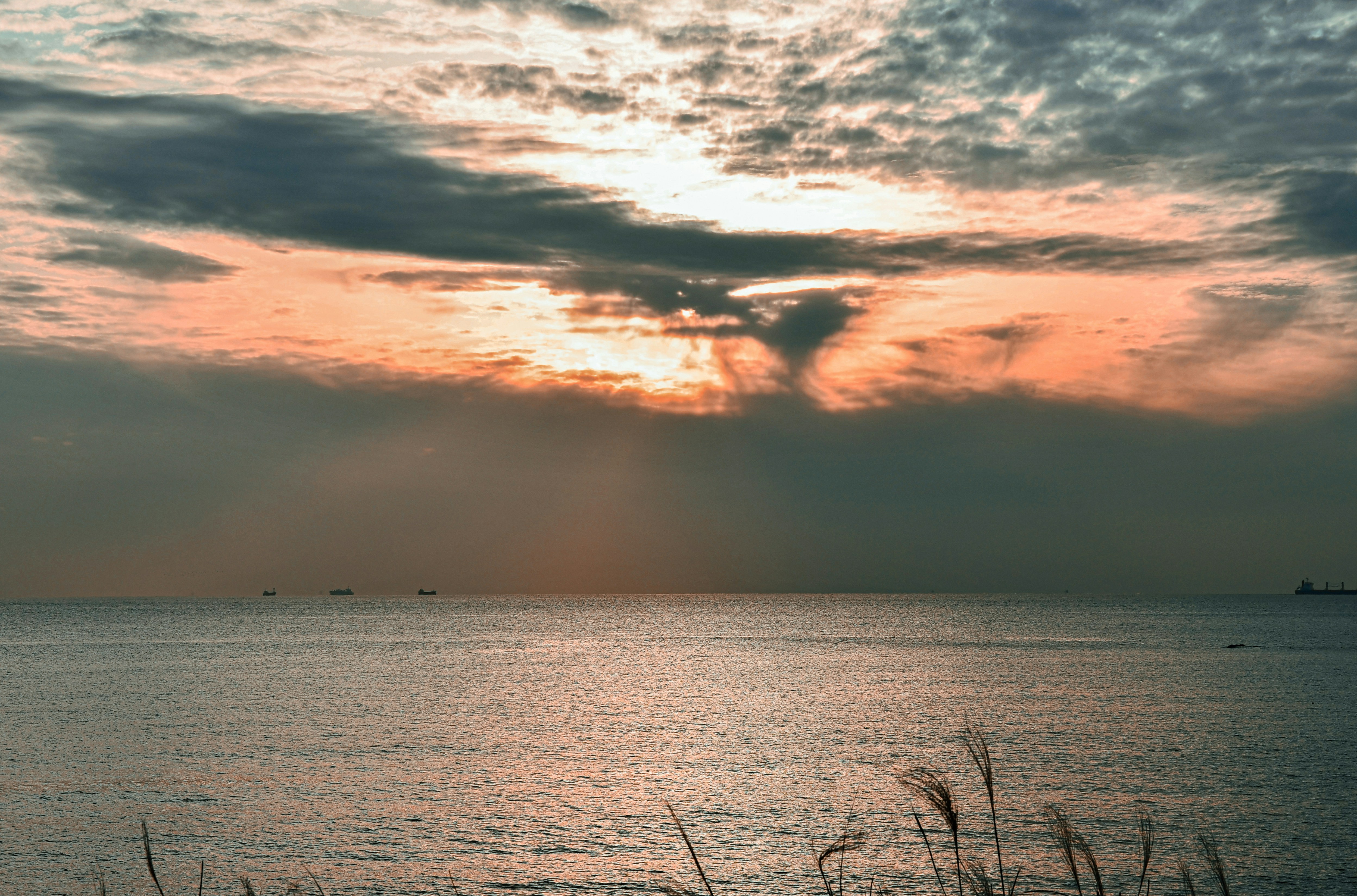 a large body of water under a cloudy sky