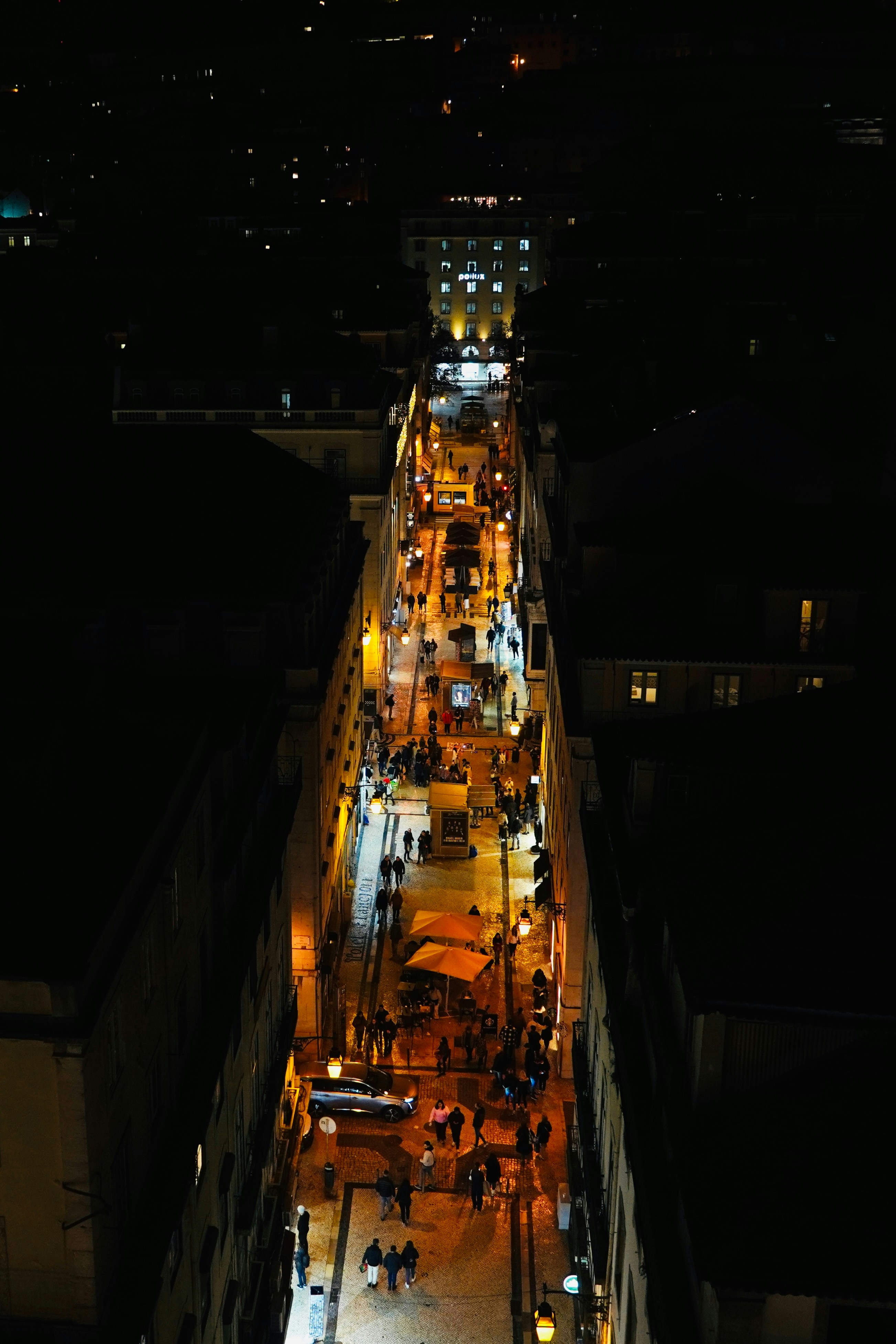 a city street at night with a lot of people