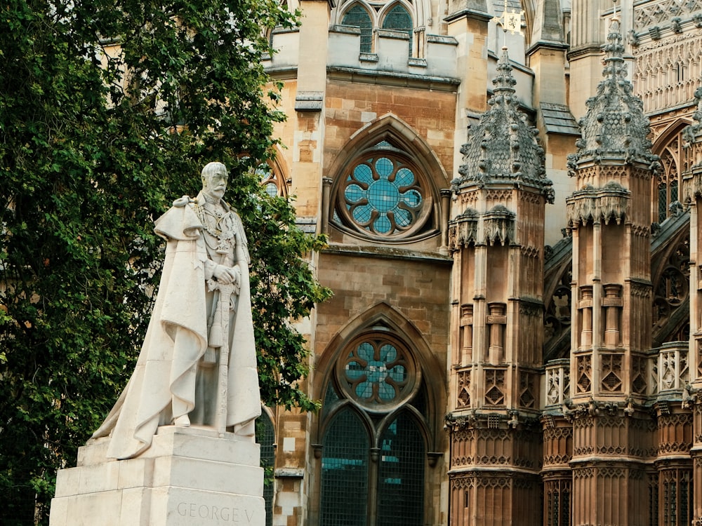 a statue in front of a large building