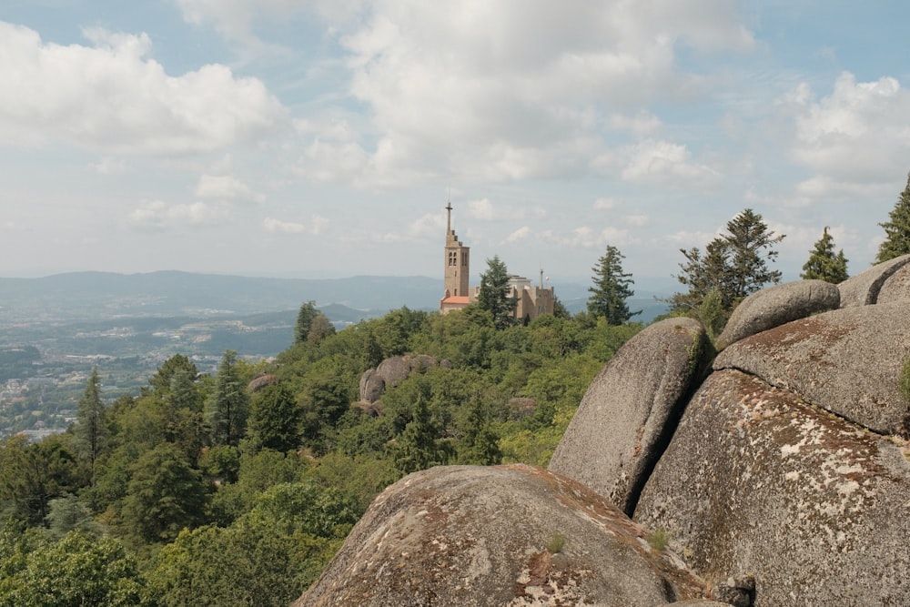 a church on top of a hill surrounded by trees