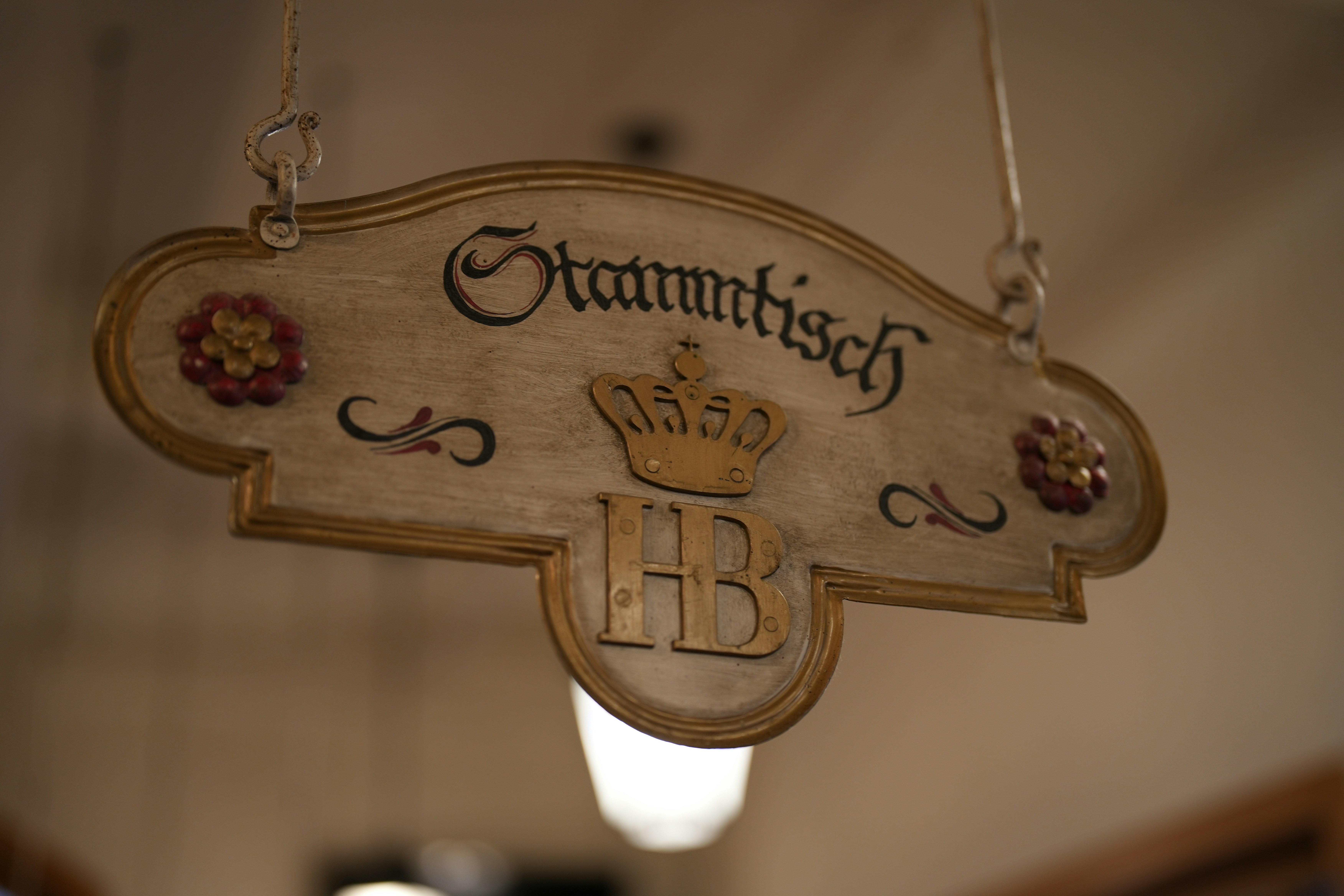 a sign hanging from the ceiling of a building, 