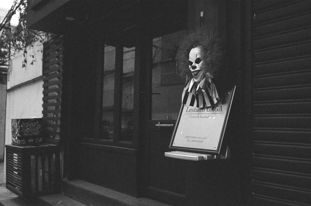 a sign with a skeleton head on it in front of a building