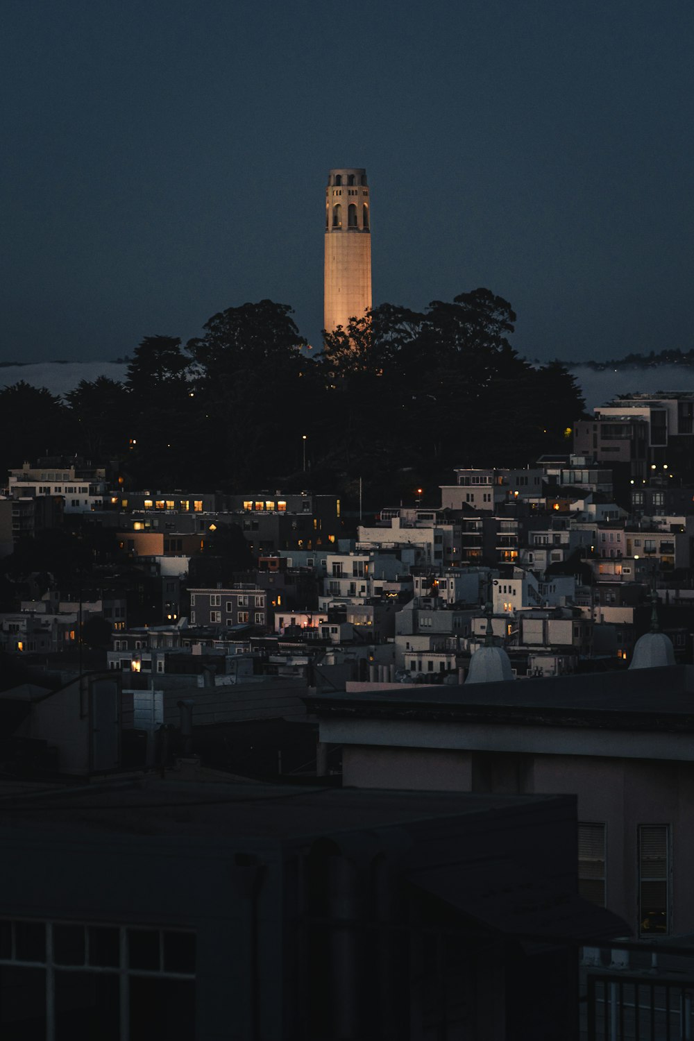 a very tall clock tower towering over a city