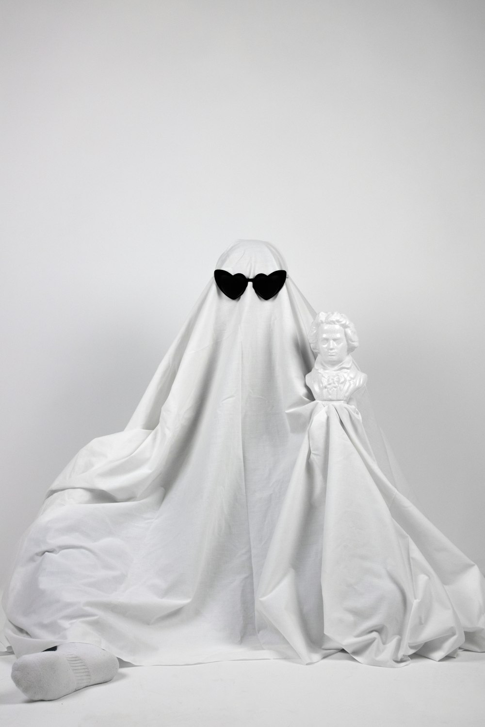 a white ghost with black eyes and a white cloak