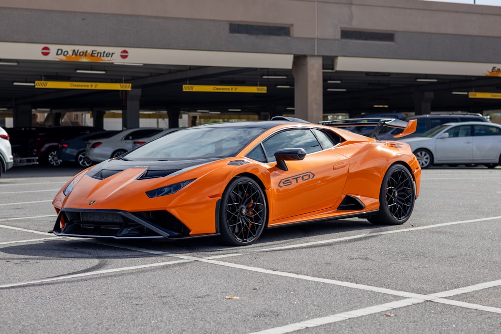 an orange sports car parked in a parking lot