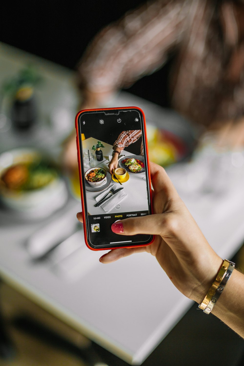 a person taking a picture of food on a cell phone