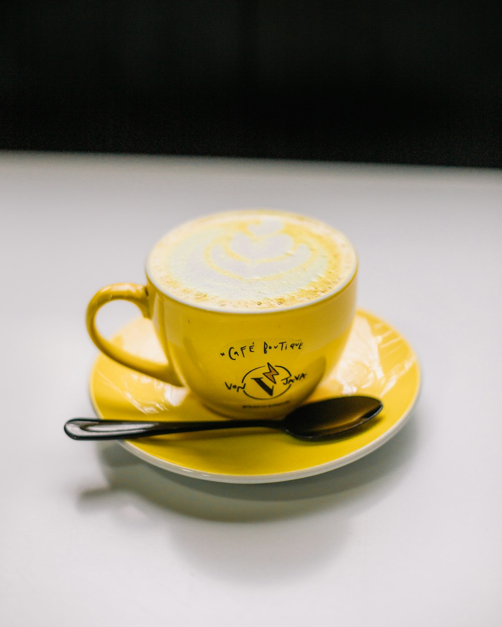 a cup of coffee with a spoon on a saucer