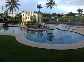 a large swimming pool with a slide in the middle of it