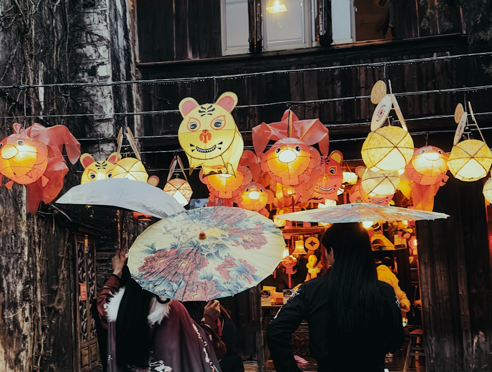 a group of people holding umbrellas in front of a building