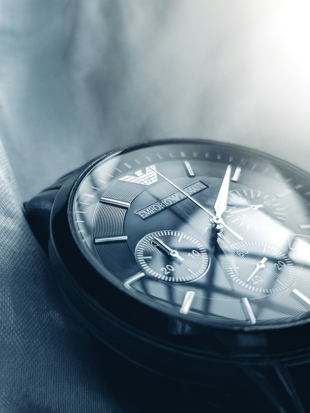 a close up of a watch on a white cloth