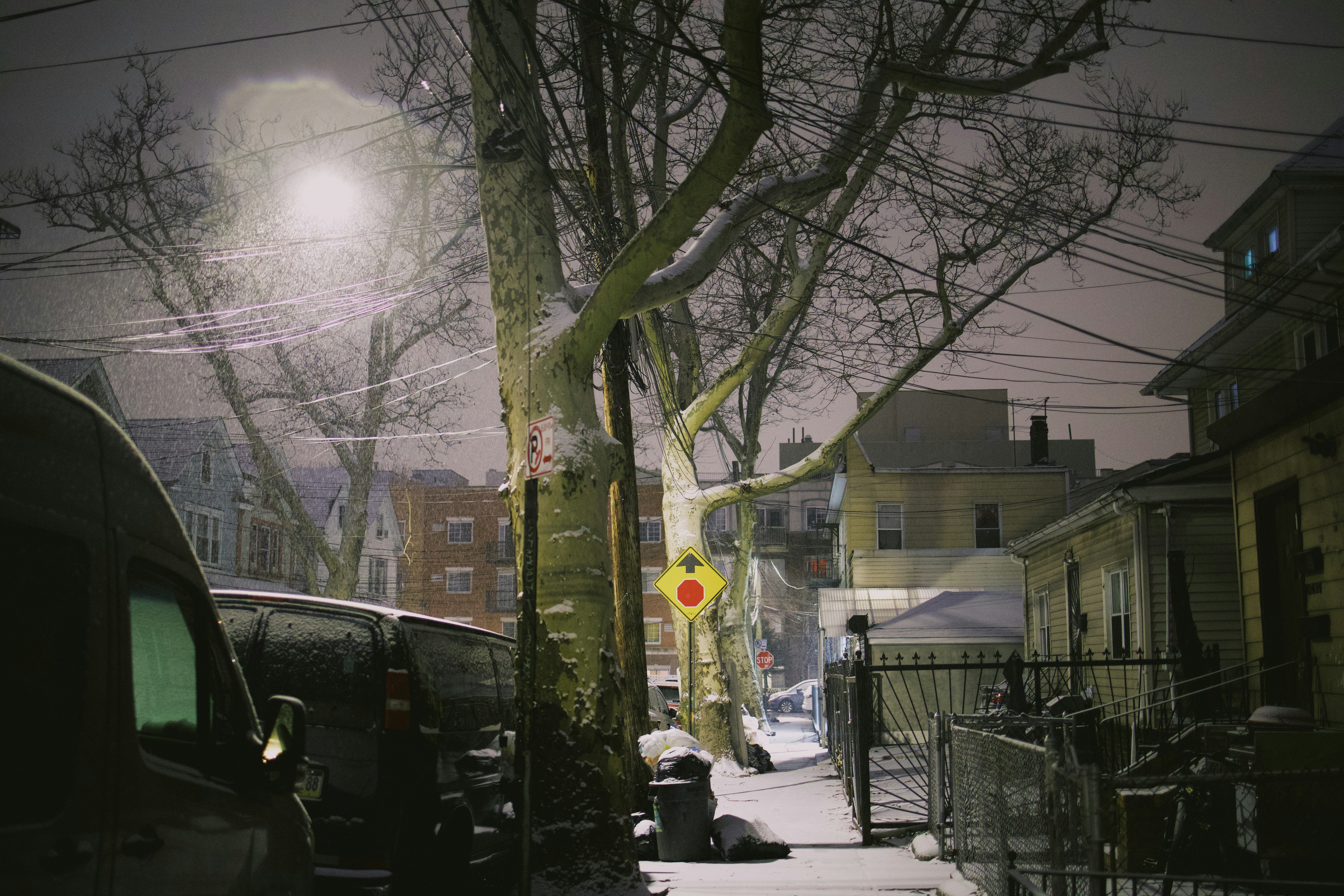 A snowy street with cars parked on the side of it photo – Free Queens ...