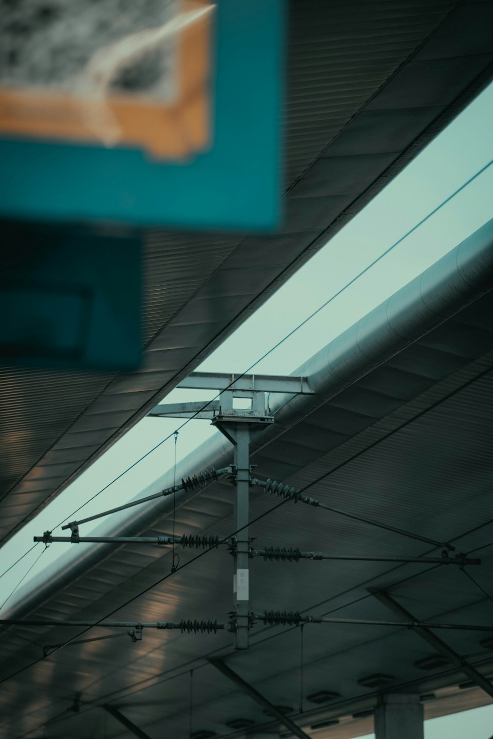 a close up of a train station ceiling with wires