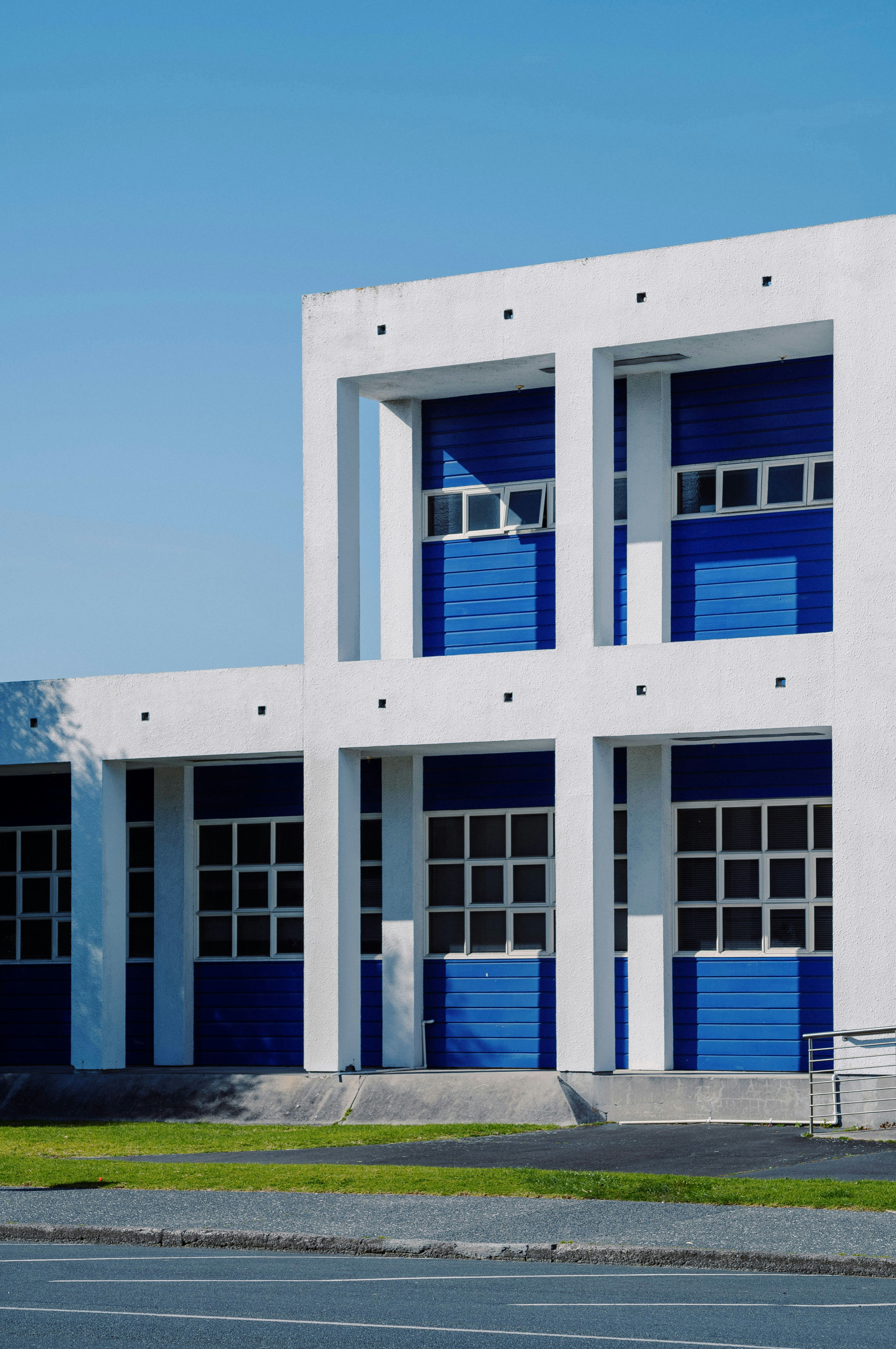 a large white building with blue doors and windows