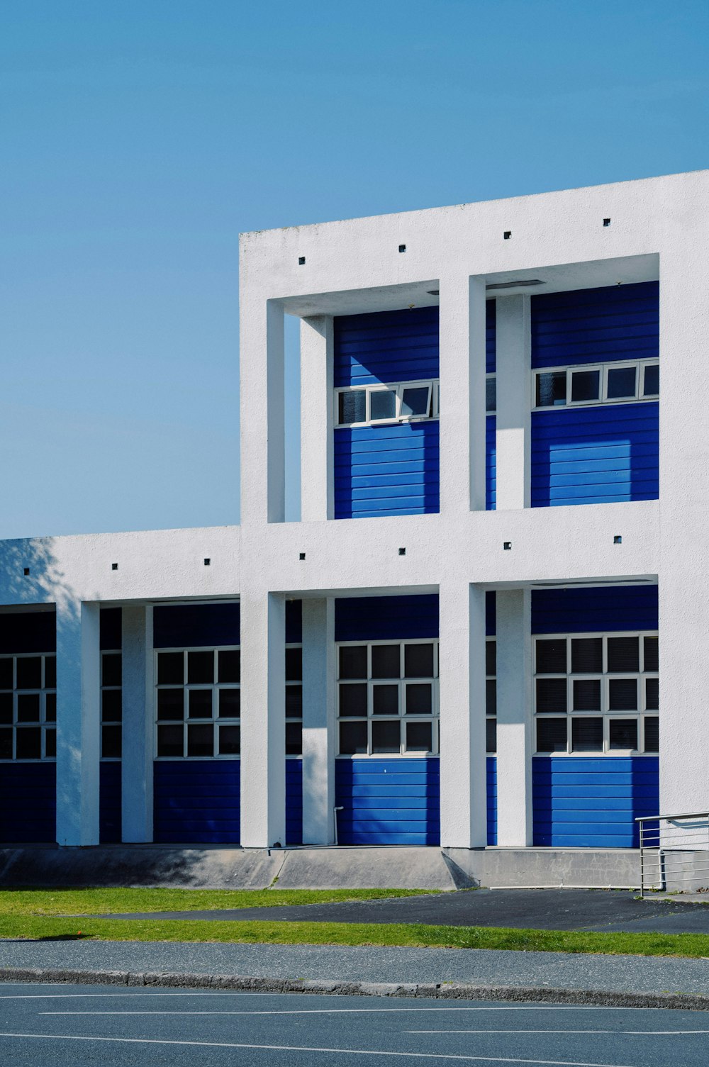 a large white building with blue doors and windows