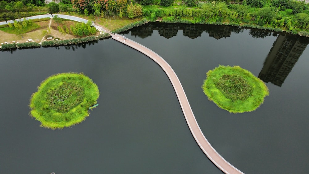 an aerial view of a lake and a bridge