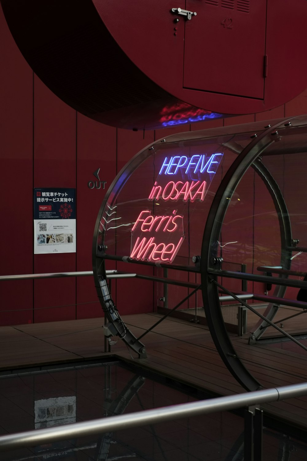 a bicycle wheel with a neon sign on the side of it