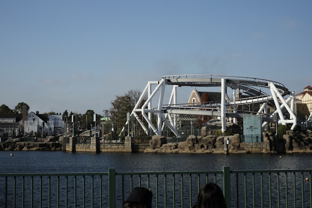 a roller coaster going over a body of water