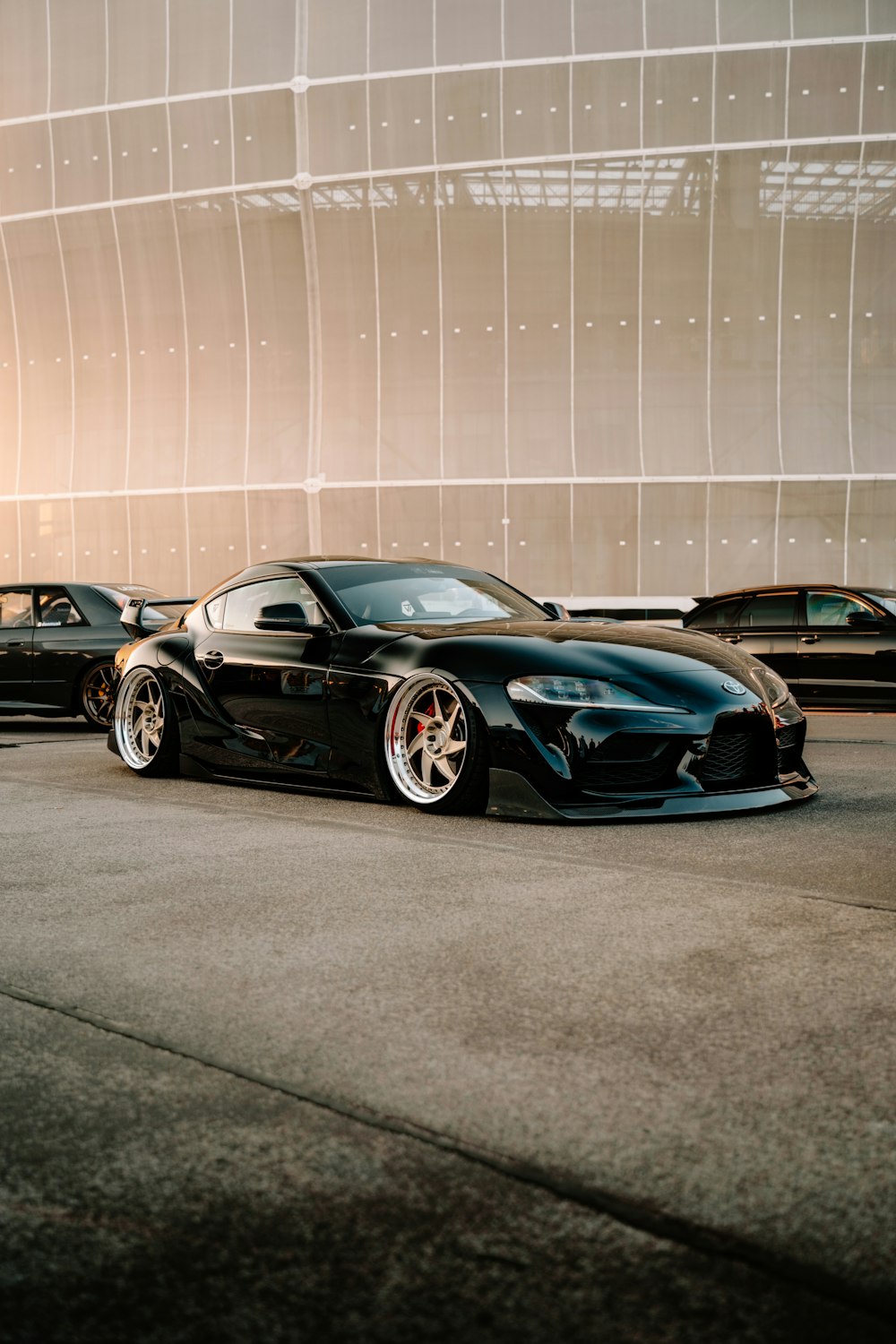 a black sports car parked in front of a building