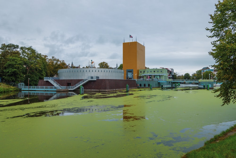 a body of water with a building in the background