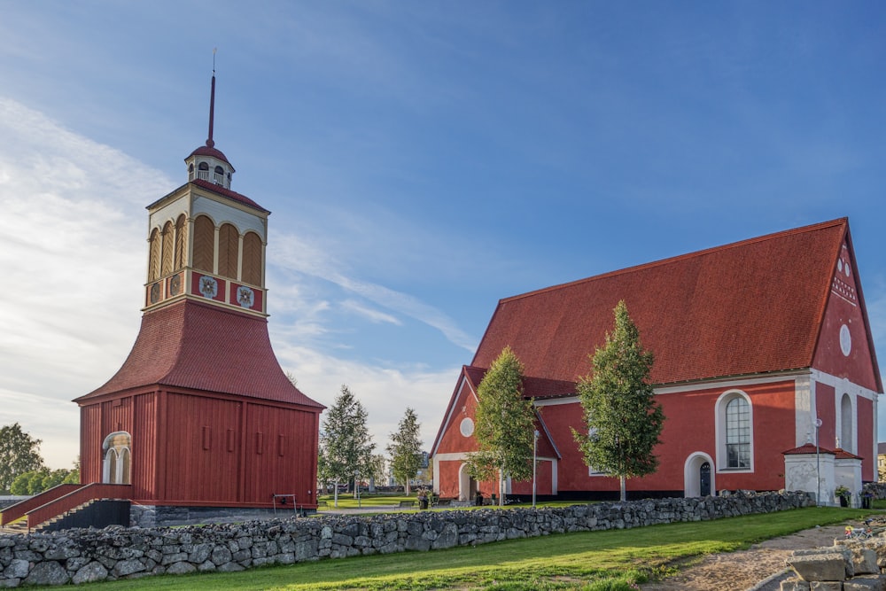 a church with a steeple and a stone wall