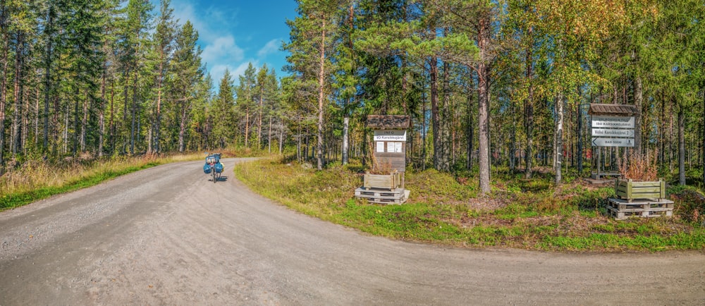 a person riding a motorcycle down a dirt road