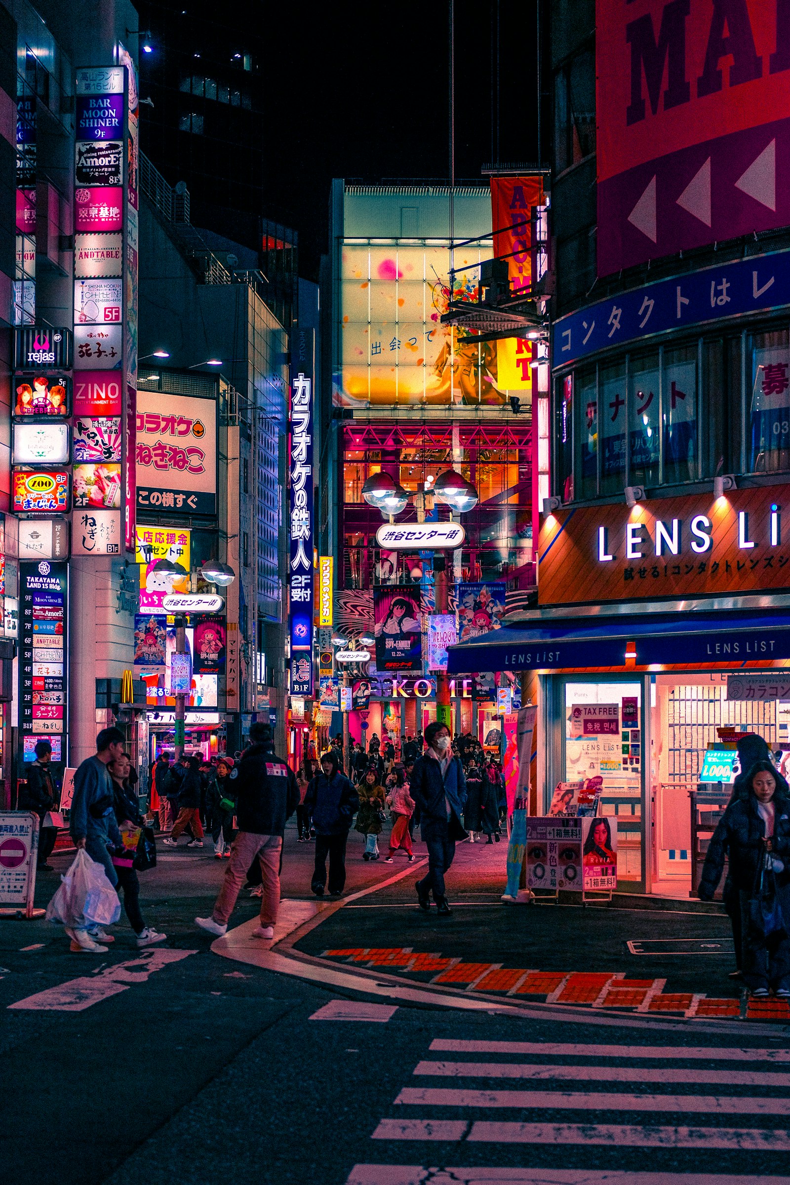 A bright, neon-lit shopping street in Tokyo
