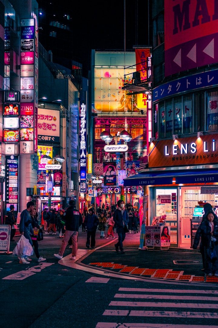 A bright, neon-lit shopping street in Tokyo