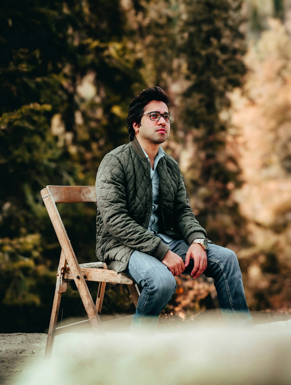 a man sitting on top of a wooden bench