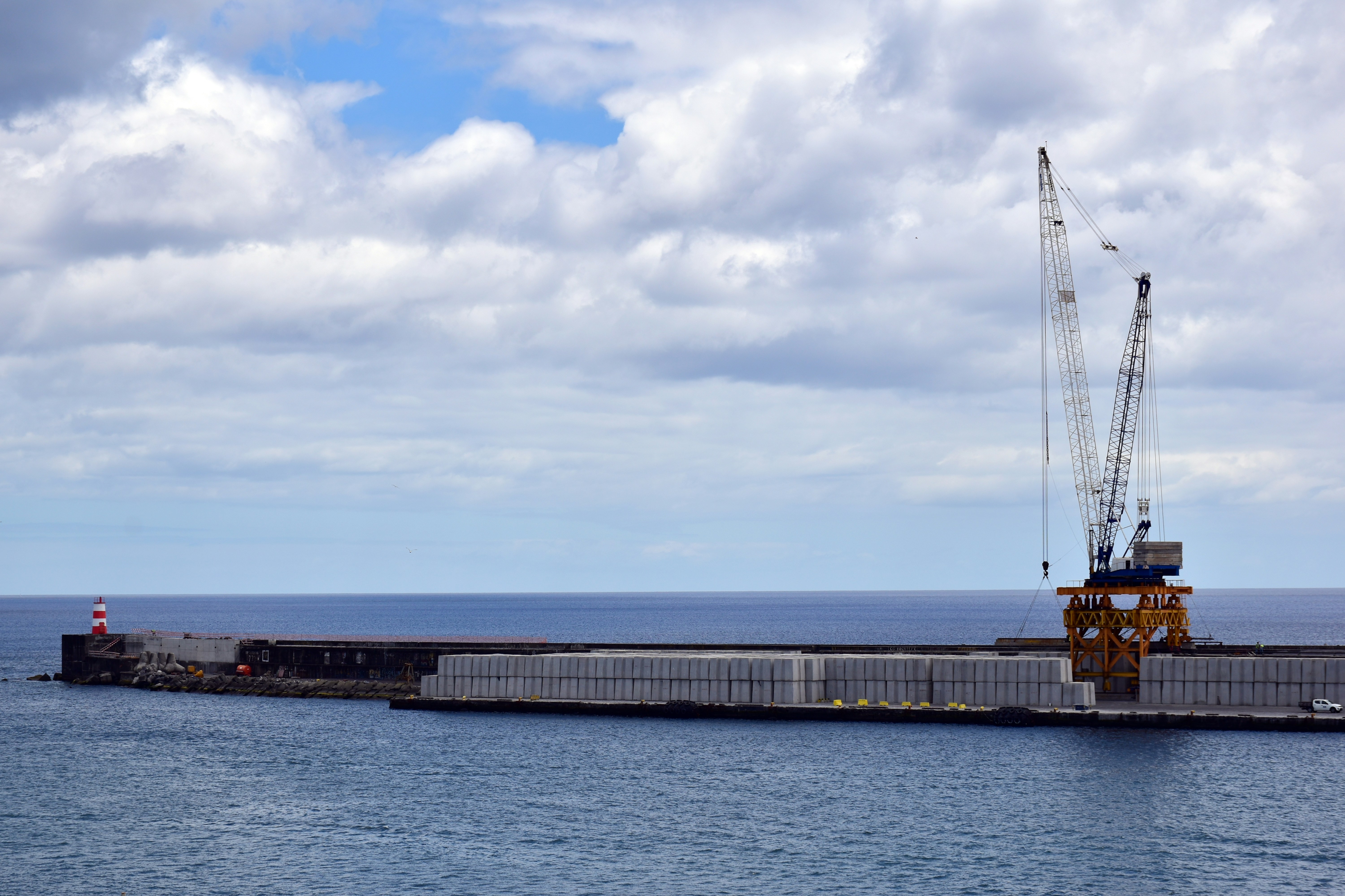 a large body of water with a crane on top of it, A crane on the quay (Little activity)