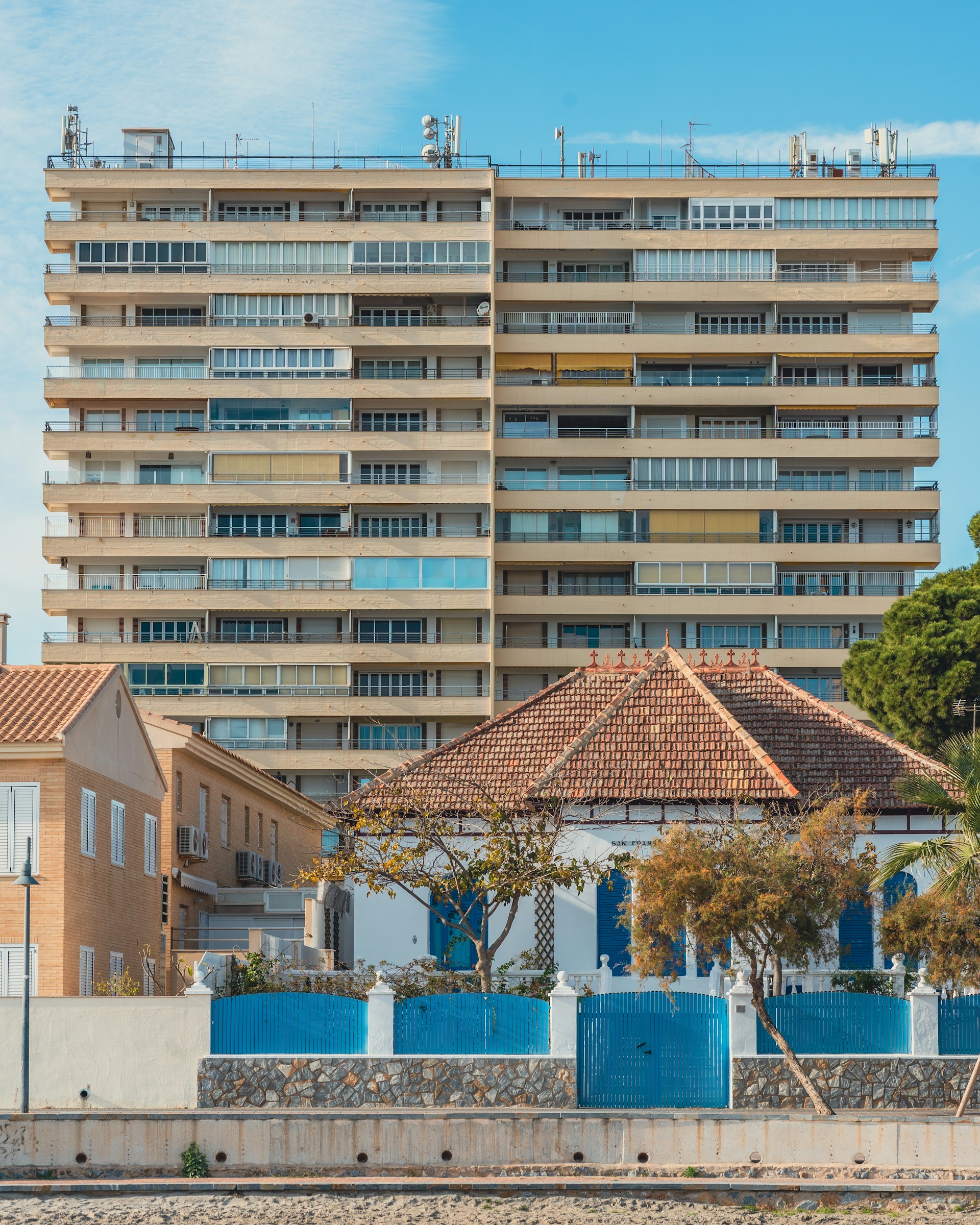a tall building with balconies on top of it