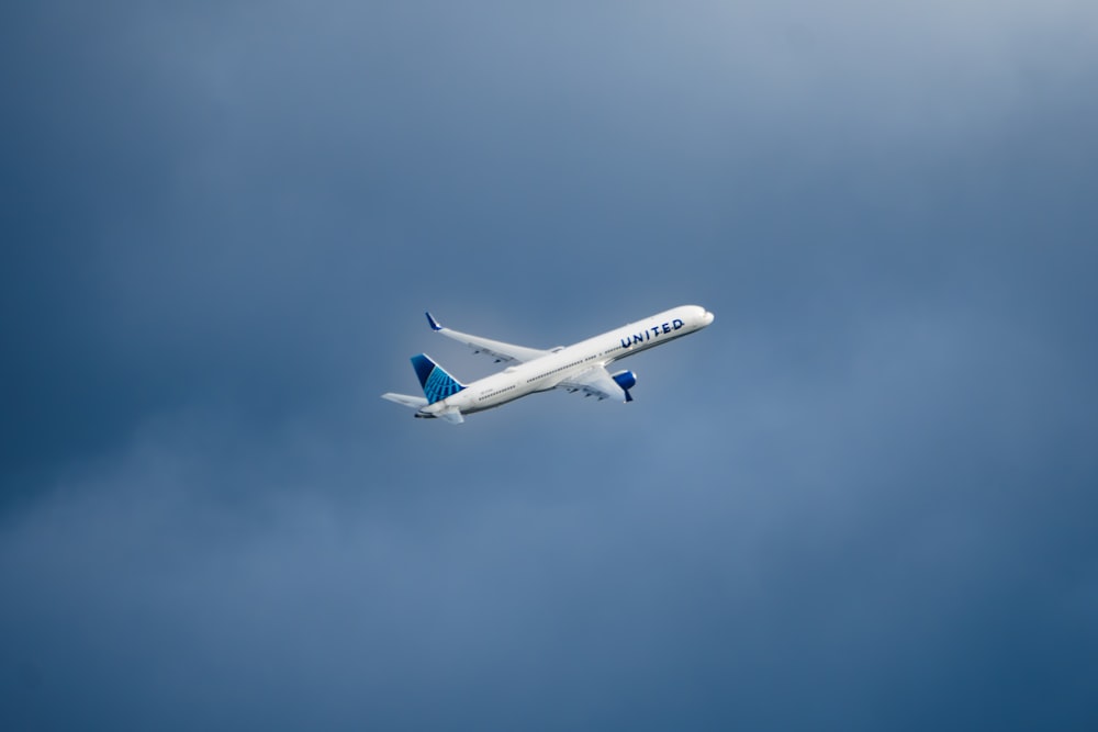 a large passenger jet flying through a cloudy blue sky