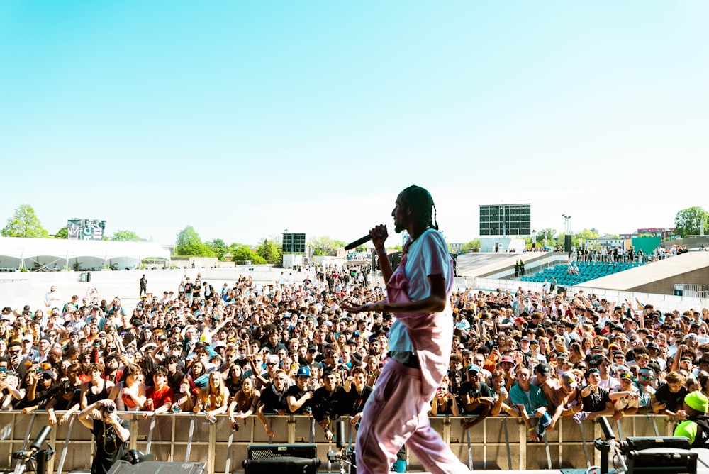 a man standing on top of a stage in front of a crowd