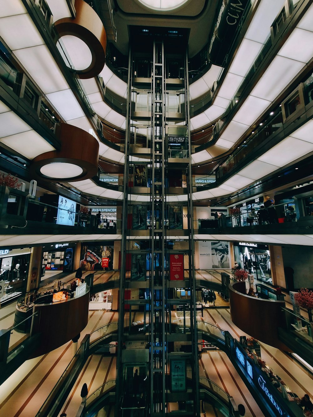 a view of a shopping mall from the top of the escalator