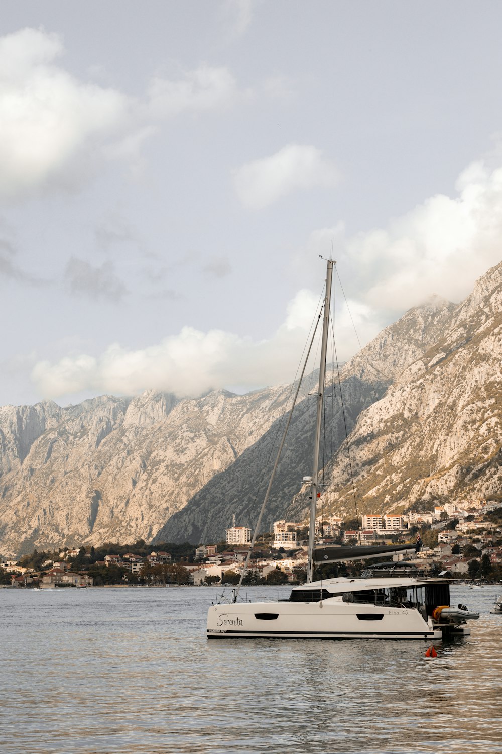 a white boat floating on top of a body of water