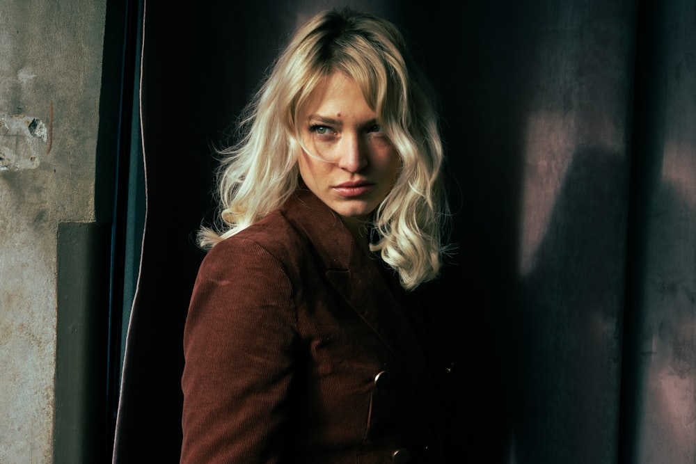 a woman with blonde hair standing in a doorway