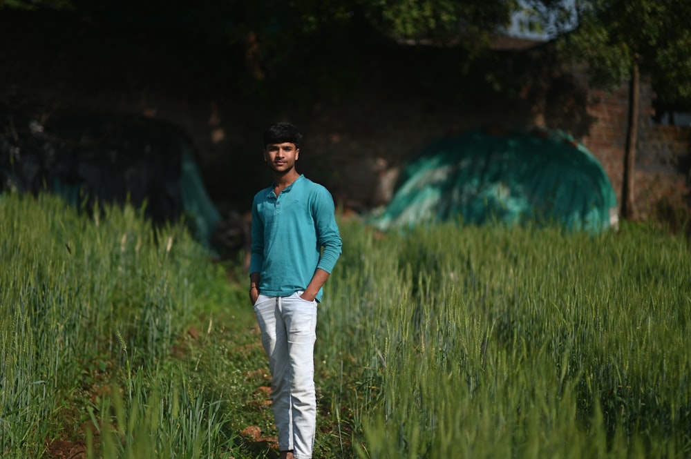 a man standing in a field of tall grass