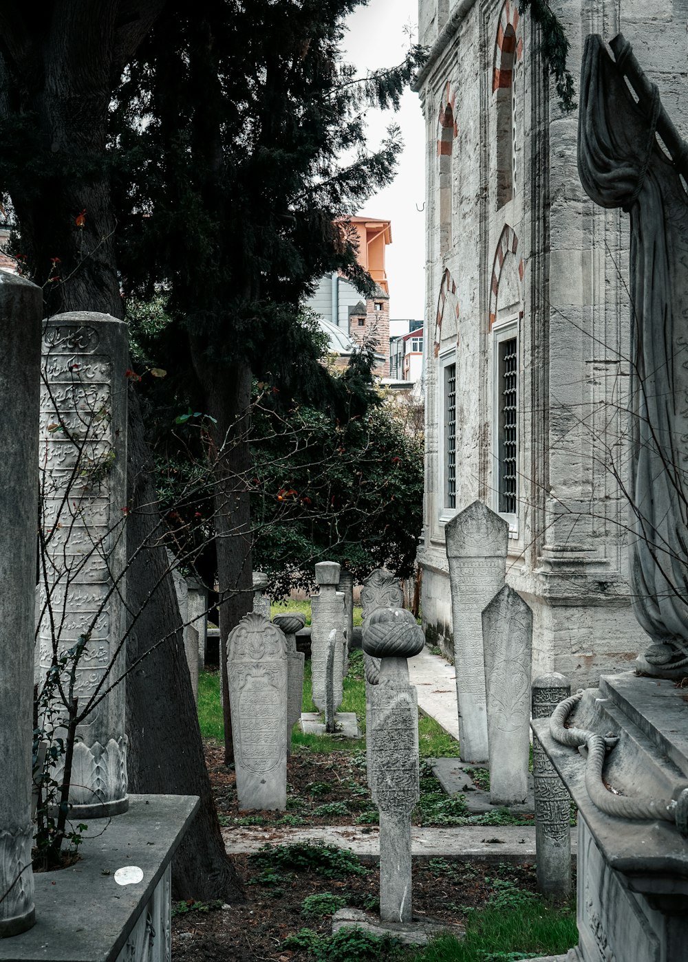 a cemetery with several headstones and trees