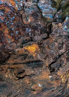 a close up of a rock with a yellow and blue substance on it