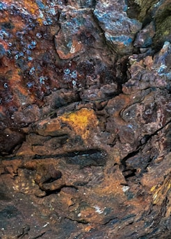 a close up of a rock with a yellow and blue substance on it