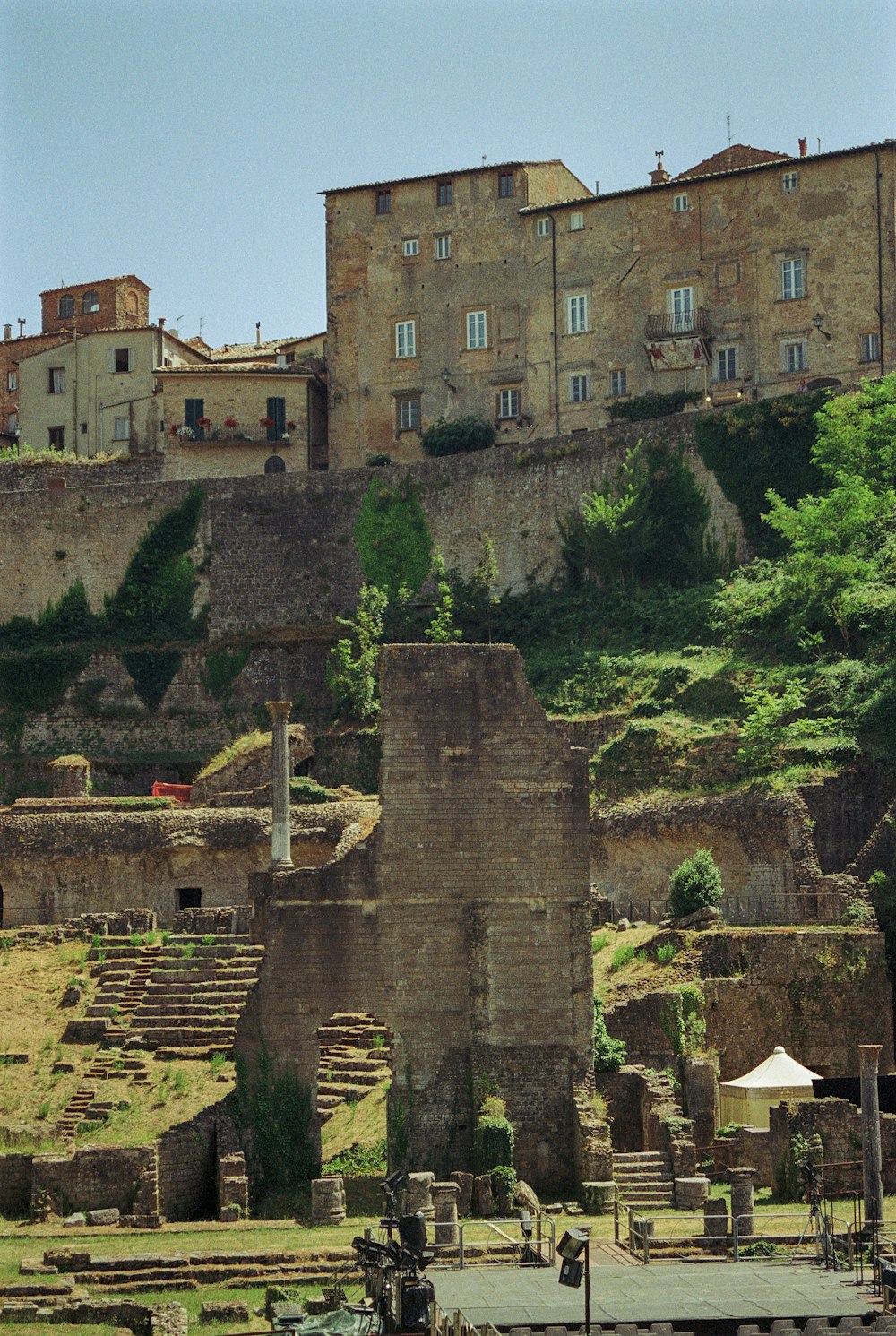 a large stone building sitting on top of a lush green hillside