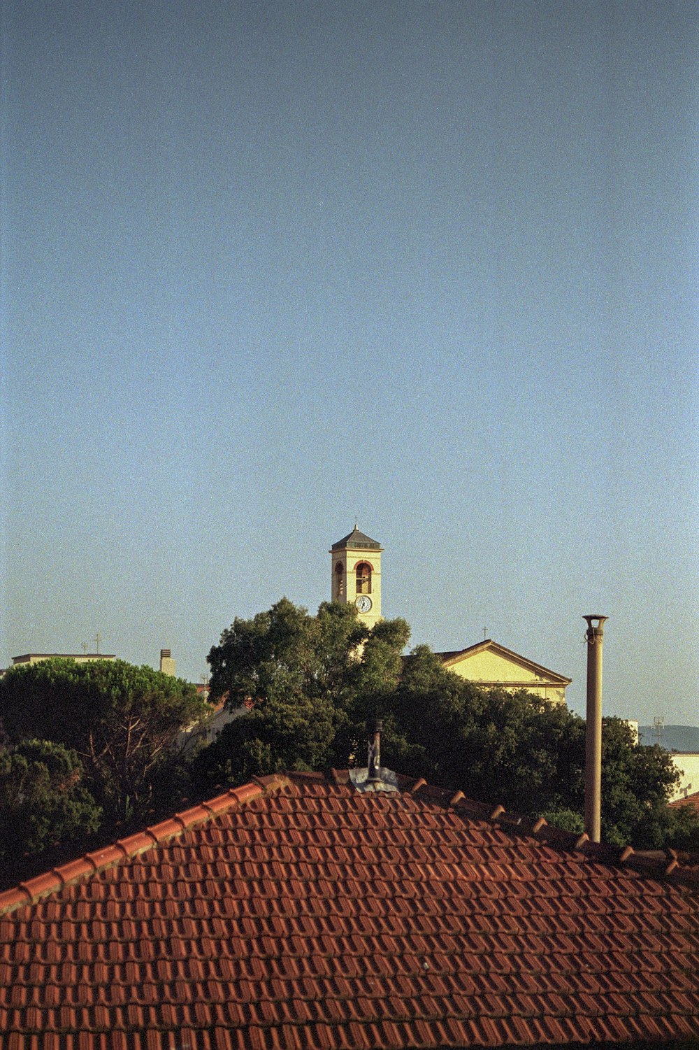 a view of a building with a clock tower in the background
