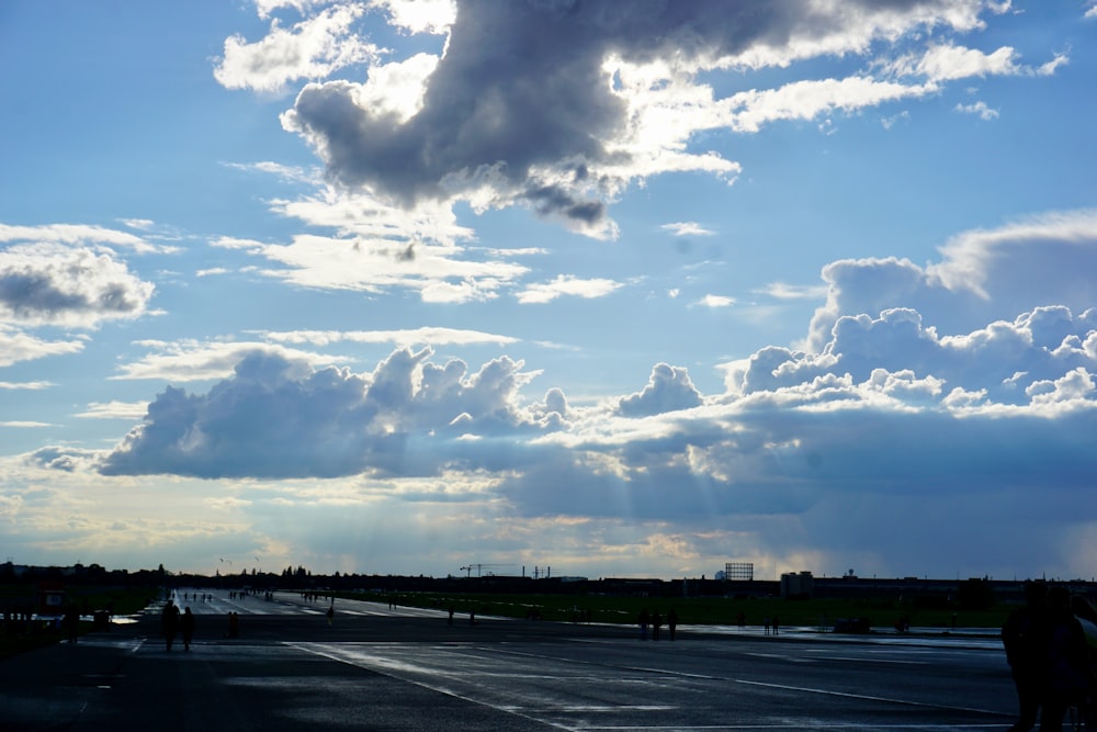 the sun shines through the clouds over a parking lot