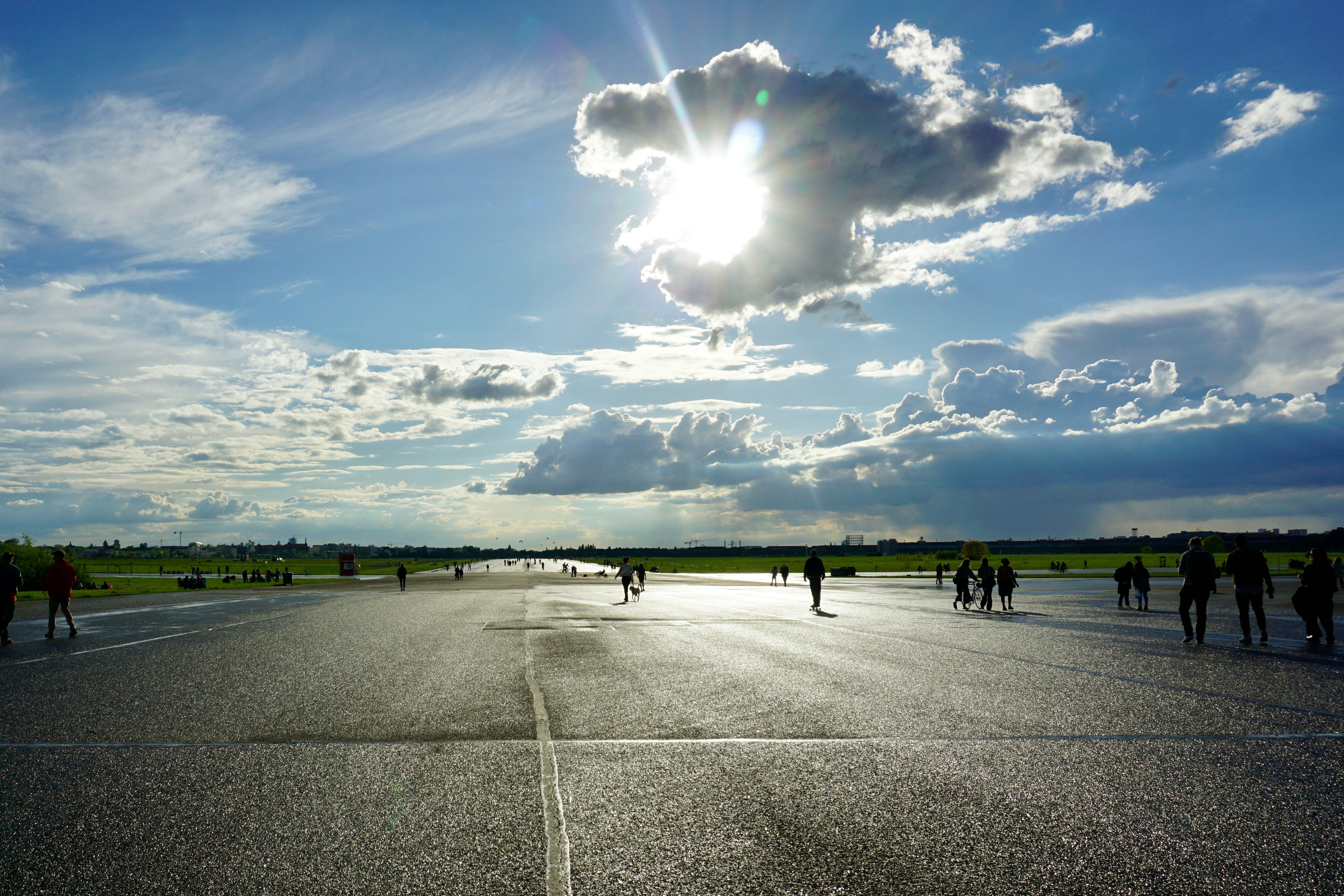 a group of people walking across a parking lot