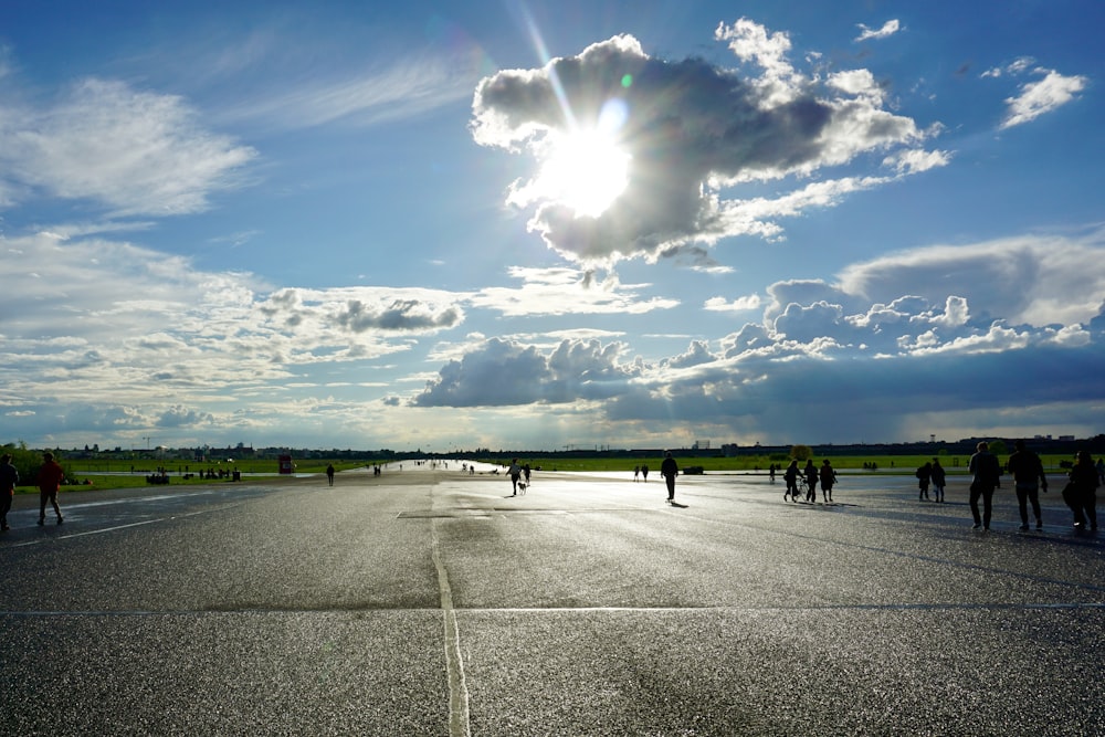 a group of people walking across a parking lot